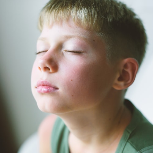 Young boy breathing eyes closed