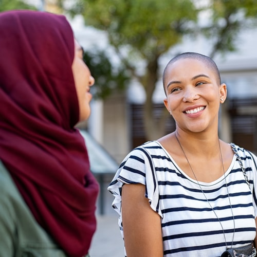 Two women sitting outdoors talking